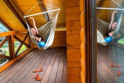 Girl laying enjoying the benefits of a hanging chair